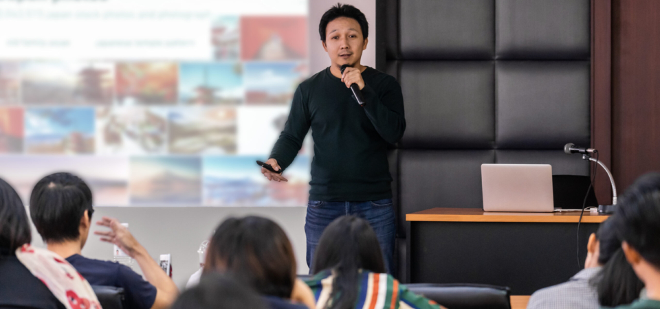 Asian Speaker or lecture with casual suit on the stage presentin